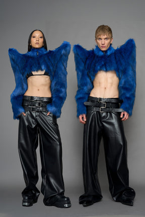 model wearing blue faux fur crop jacket with sharp shoulder design and black pants