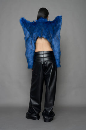 model wearing blue faux fur crop jacket with sharp shoulder design and black pants