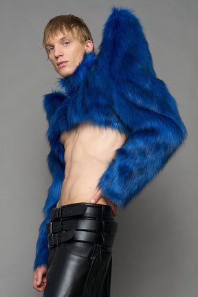 model wearing blue faux fur crop jacket with sharp shoulder design and black pants