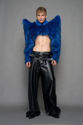 model wearing blue faux fur crop jacket with sharp shoulder design and black pants