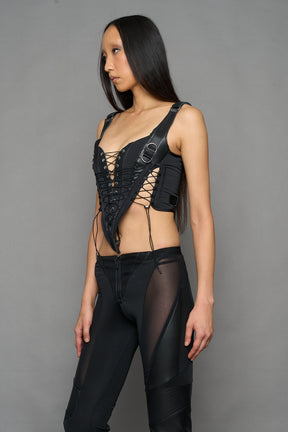 black faux leather lace up corset with sharp design details and buckle and ring details