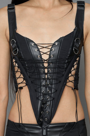 black faux leather lace up corset with sharp design details and buckle and ring details