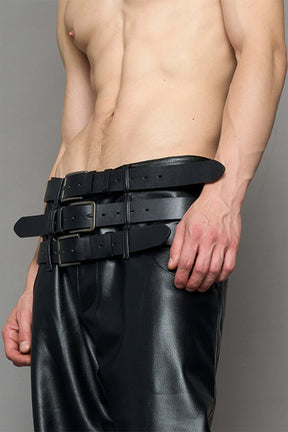 model wearing black vegan leather smooth optic baggy pants with triple belt design detail