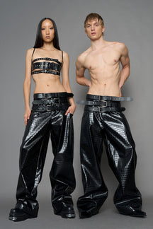 model wearing black vegan leather croc optic baggy pants with triple belt design detail