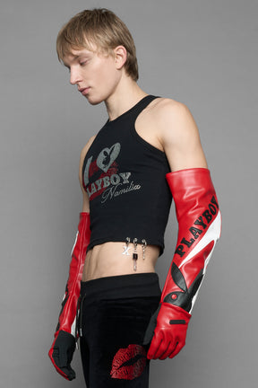 model wearing red and white Playboy x NAMILIA vegan leather gloves and mesh pants with white panels.