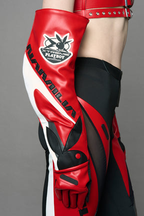 model wearing red and white Playboy x NAMILIA vegan leather gloves and mesh pants with white panels.