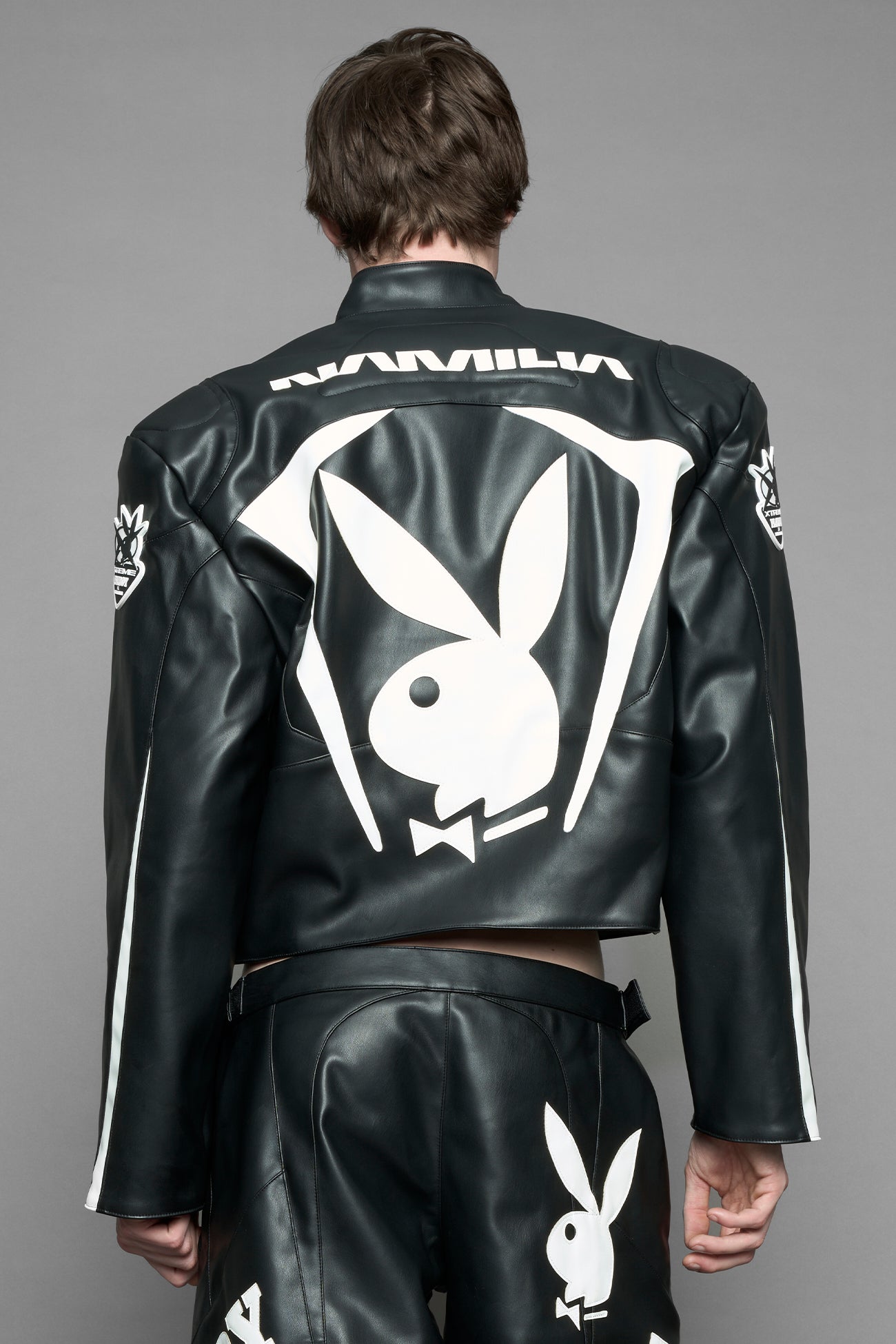 model wearing vegan leather NAMILIA x Playboy biker jacket with broad shoulder design