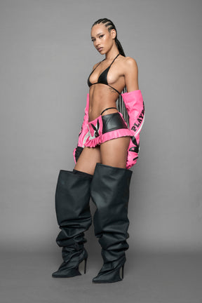 model wearing pink and white Playboy x NAMILIA vegan leather gloves and mesh pants with white panels.