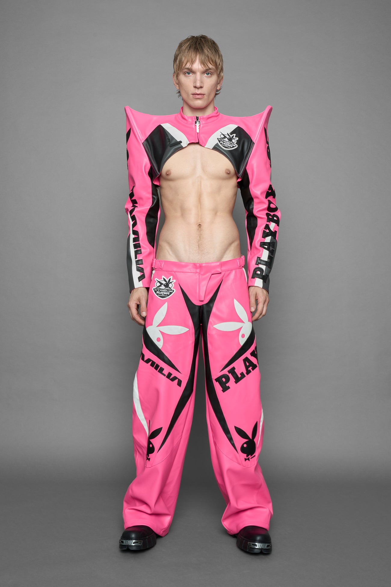 model wearing pink white vegan leather NAMILIA x PLAYBOY crop bolero jacket with sharp shoulder design 