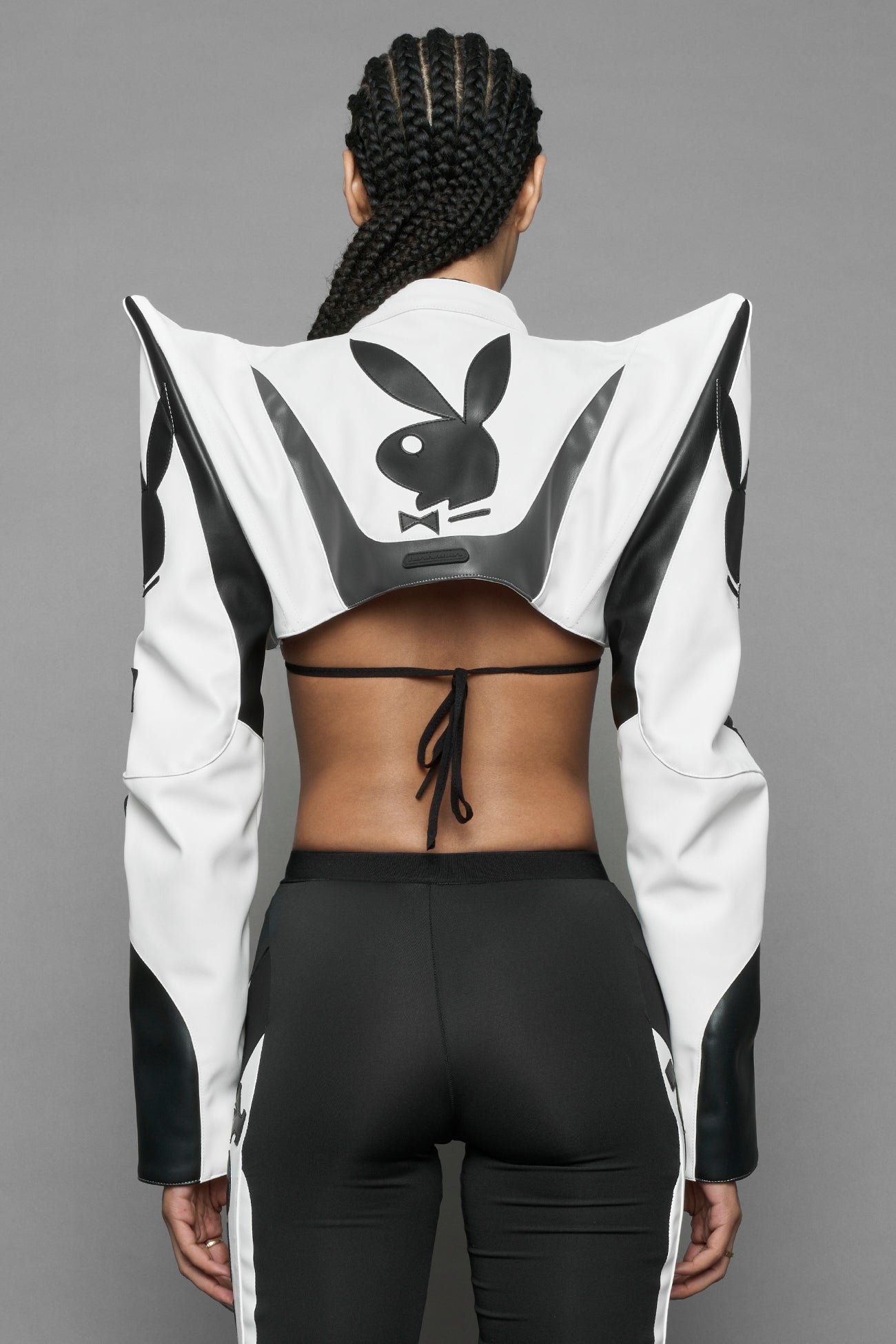 model wearing white vegan leather NAMILIA x PLAYBOY crop bolero jacket with sharp shoulder design 
