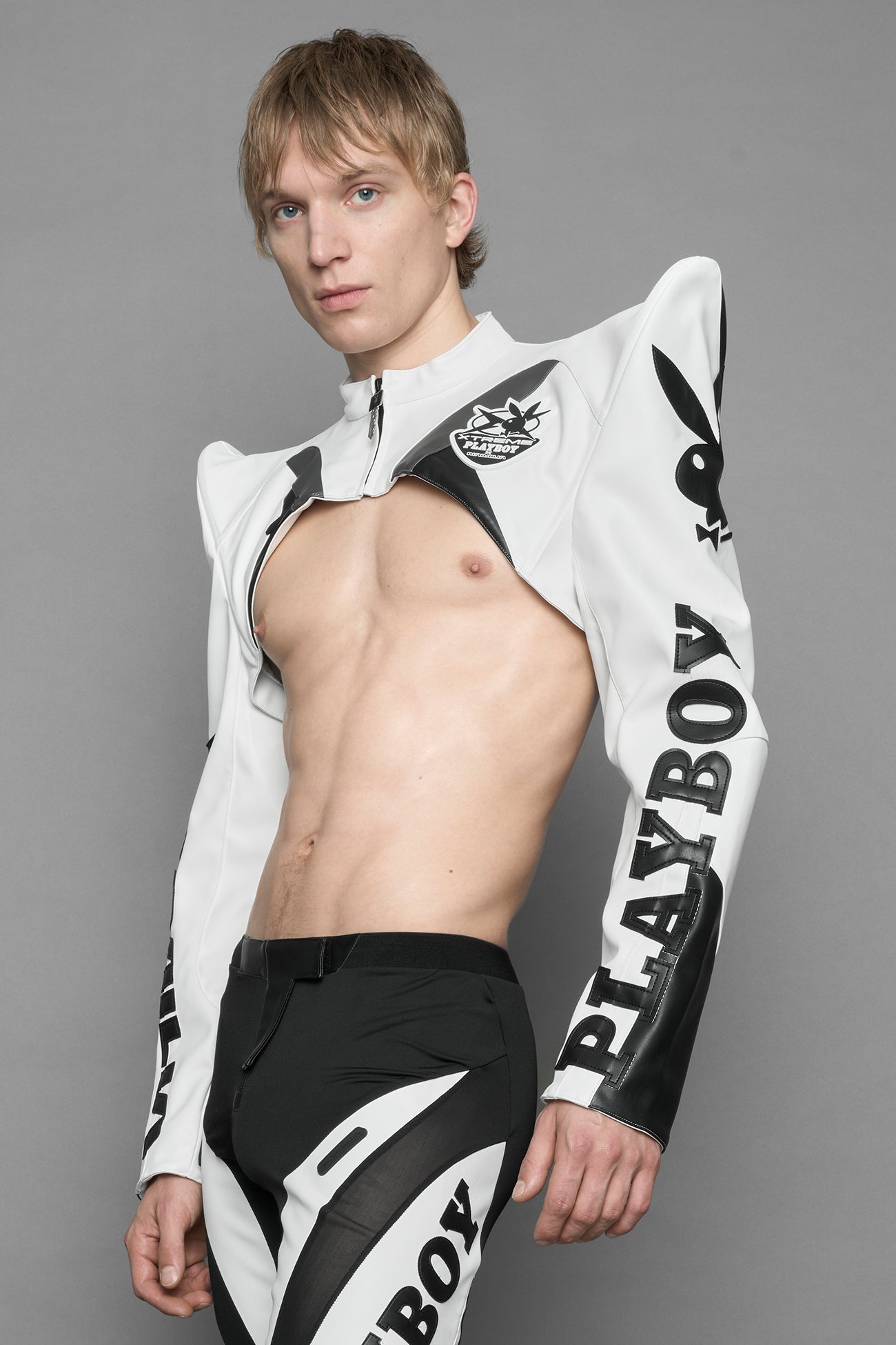 model wearing white vegan leather NAMILIA x PLAYBOY crop bolero jacket with sharp shoulder design 