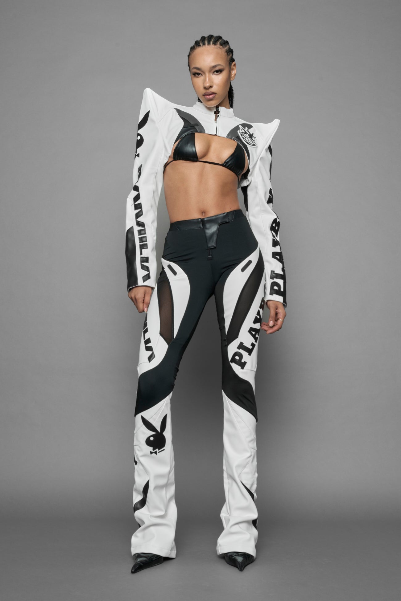 model wearing white vegan leather NAMILIA x PLAYBOY crop bolero jacket with sharp shoulder design 