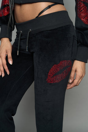 model wearing black red crystal embroidered jogger pants 