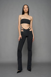 Model wearing black leggings with cut out detail