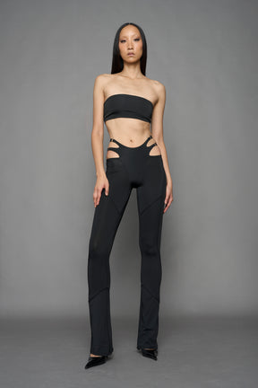 Model wearing black leggings with cut out detail
