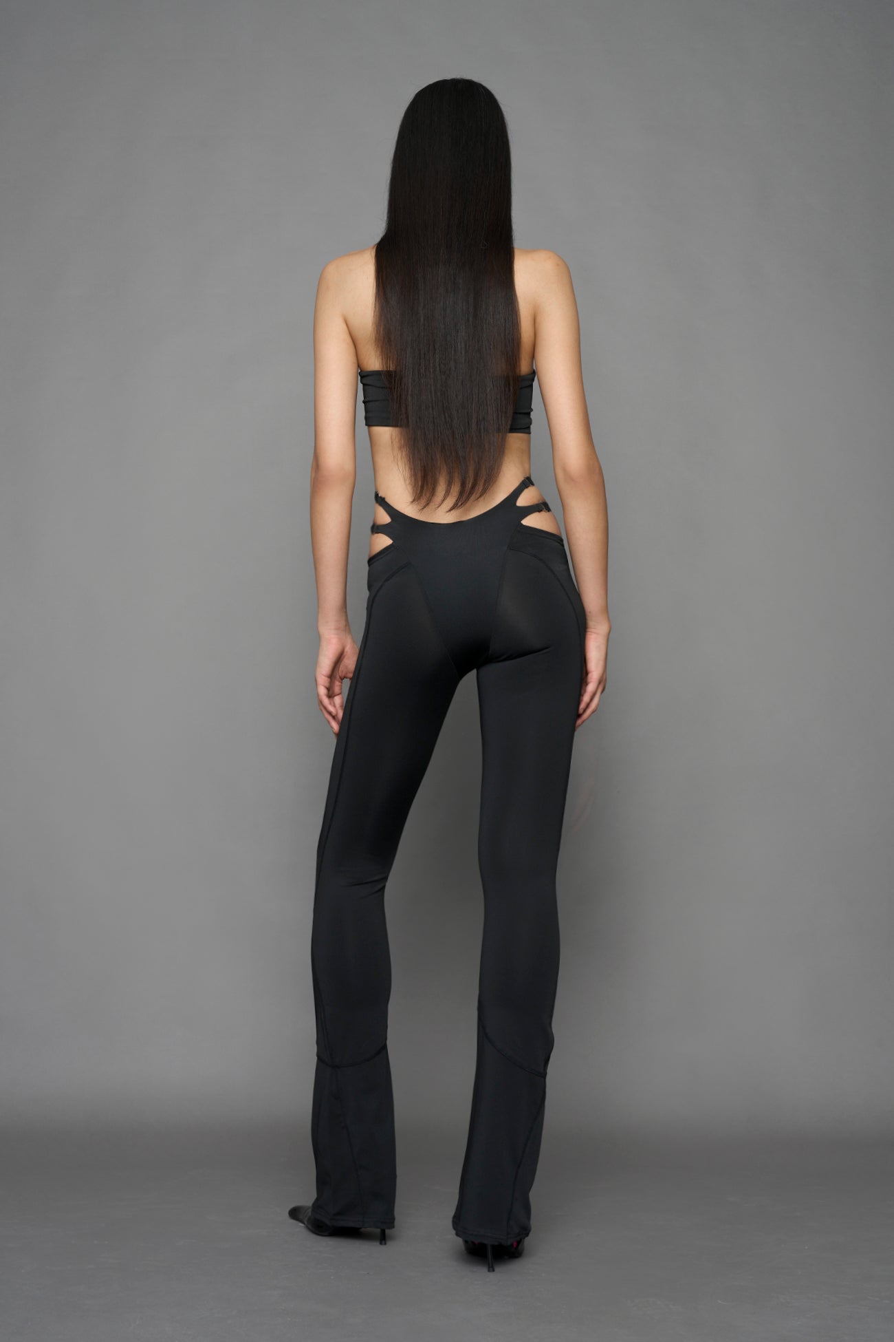 Model wearing black leggings with cut out detail