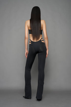 Model wearing black leggings with cut out detail