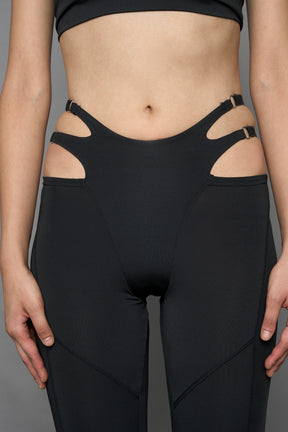 Model wearing black leggings with cut out detail